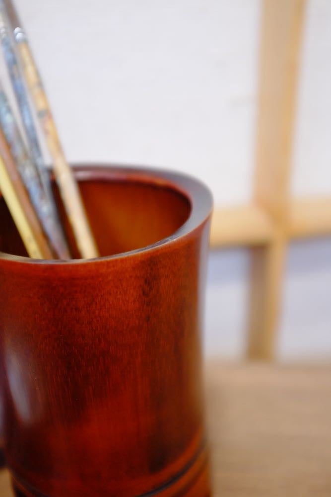 Bamboo vase and handmade drawing accessories for artistic enthusiasts.