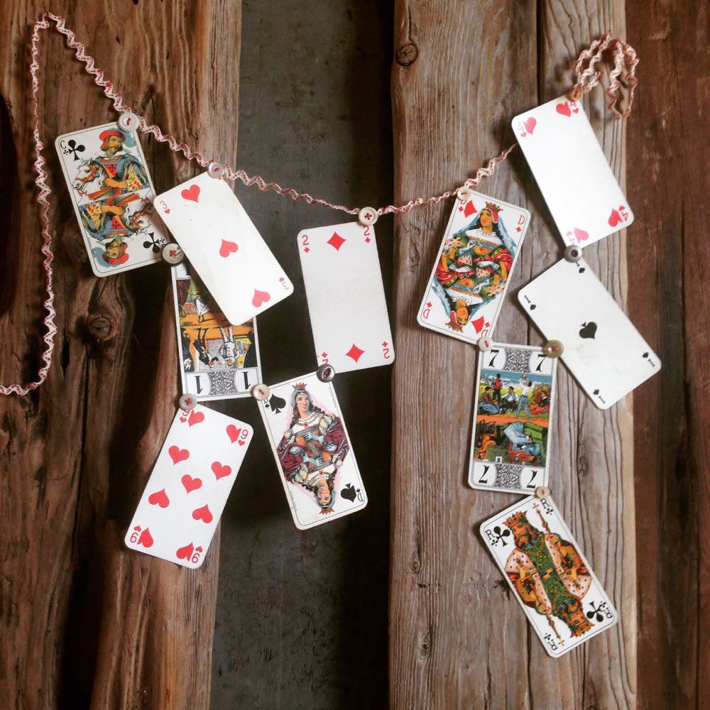 Vintage French cards on a string with decorative garland.