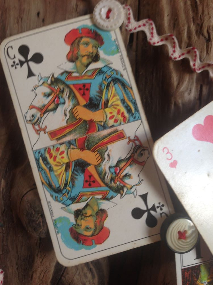 Vintage French cards on a string with decorative garland.