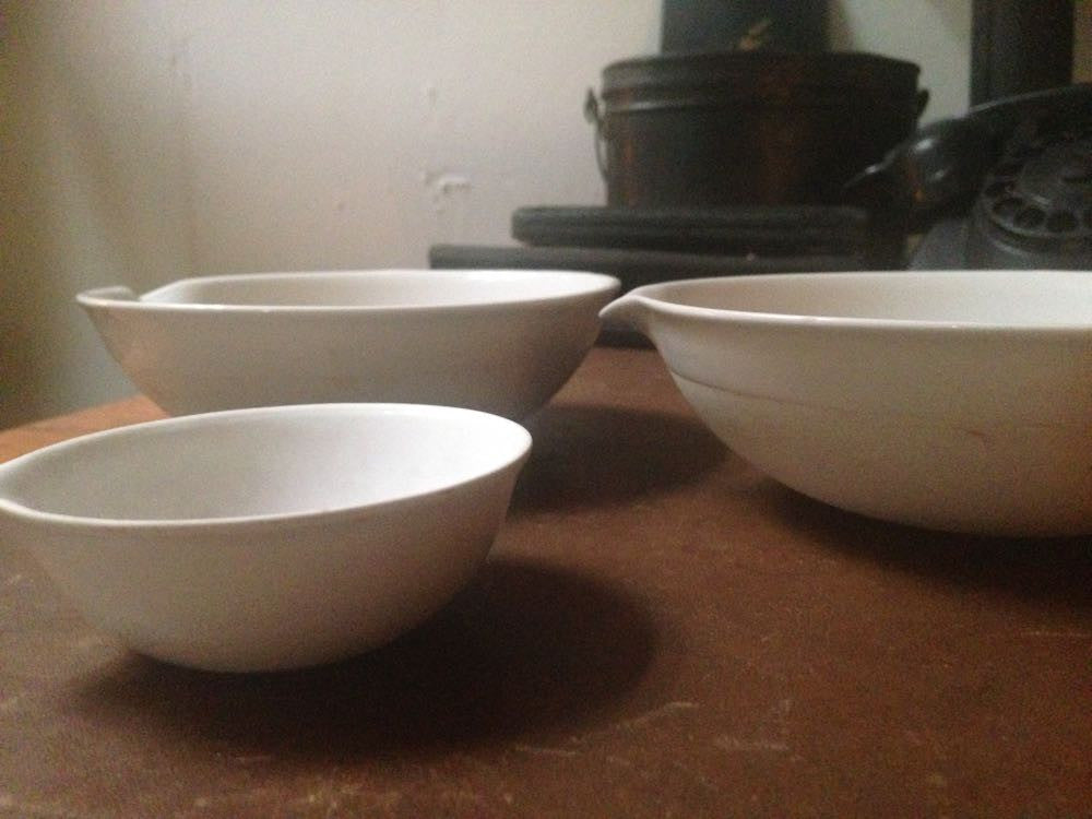 Vintage porcelain chemical bowls with laboratory equipment.