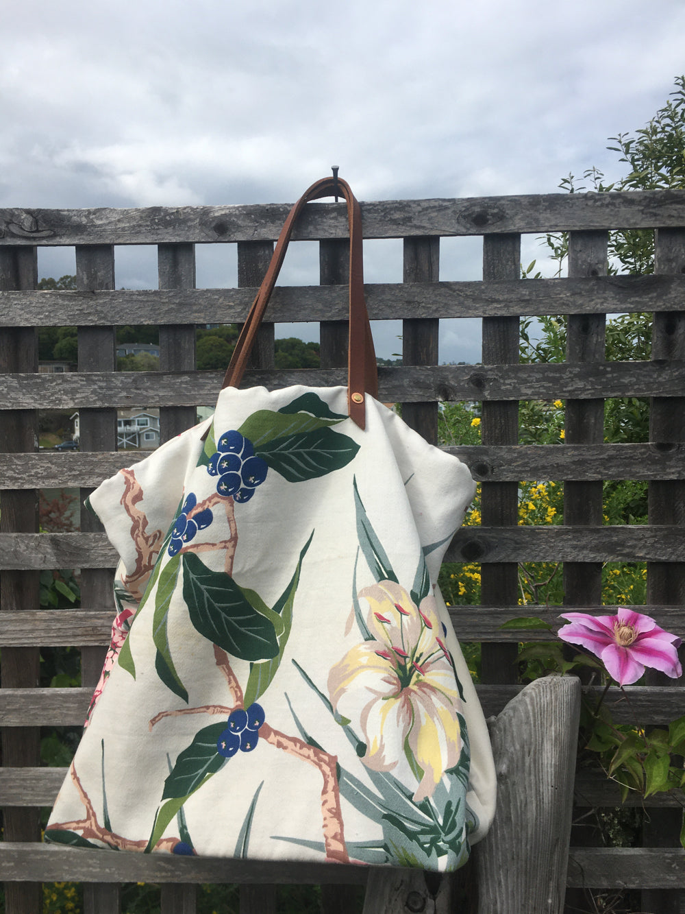 Upcycled floral shopping bag with bright blooms.