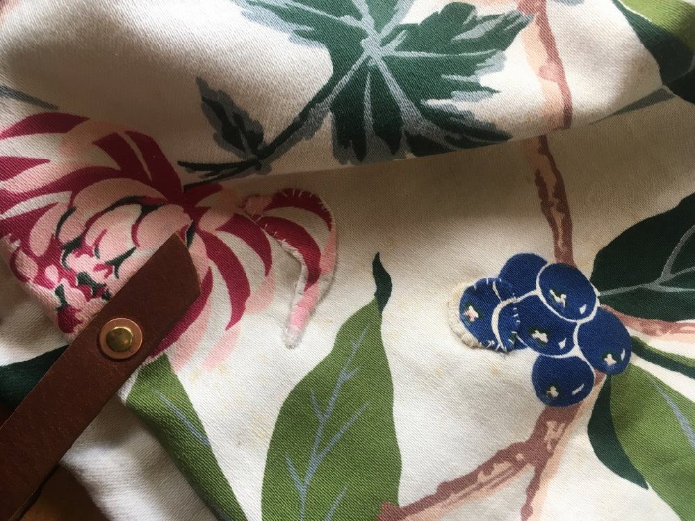 Patches have been sewn over two areas of the print.