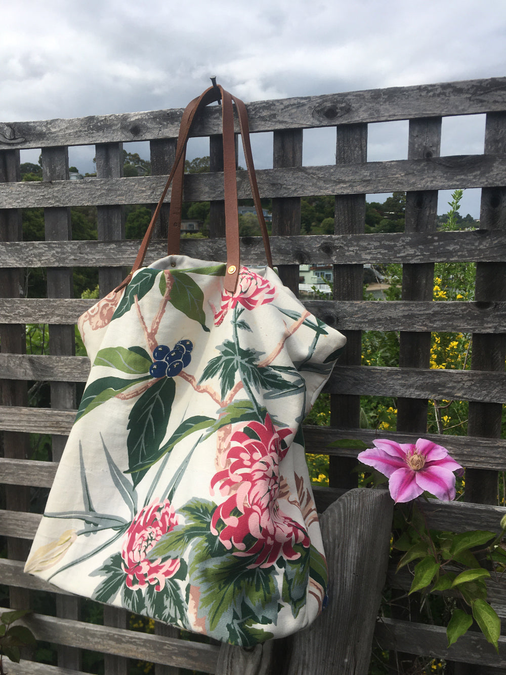 Upcycled floral shopping bag with bright blooms.