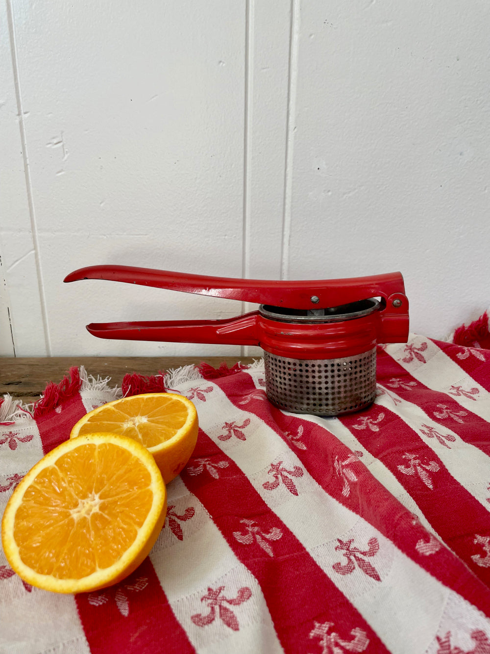 Vintage hand-held juicer on a kitchen counter