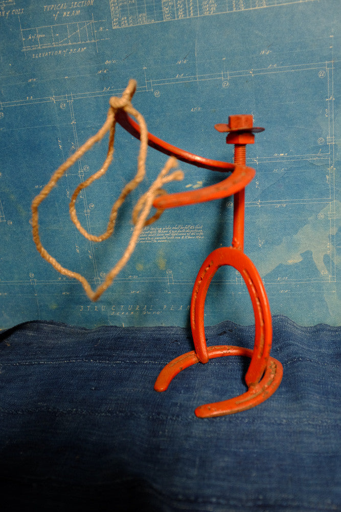 Vintage horseshoe cowboy folk art sculpture.