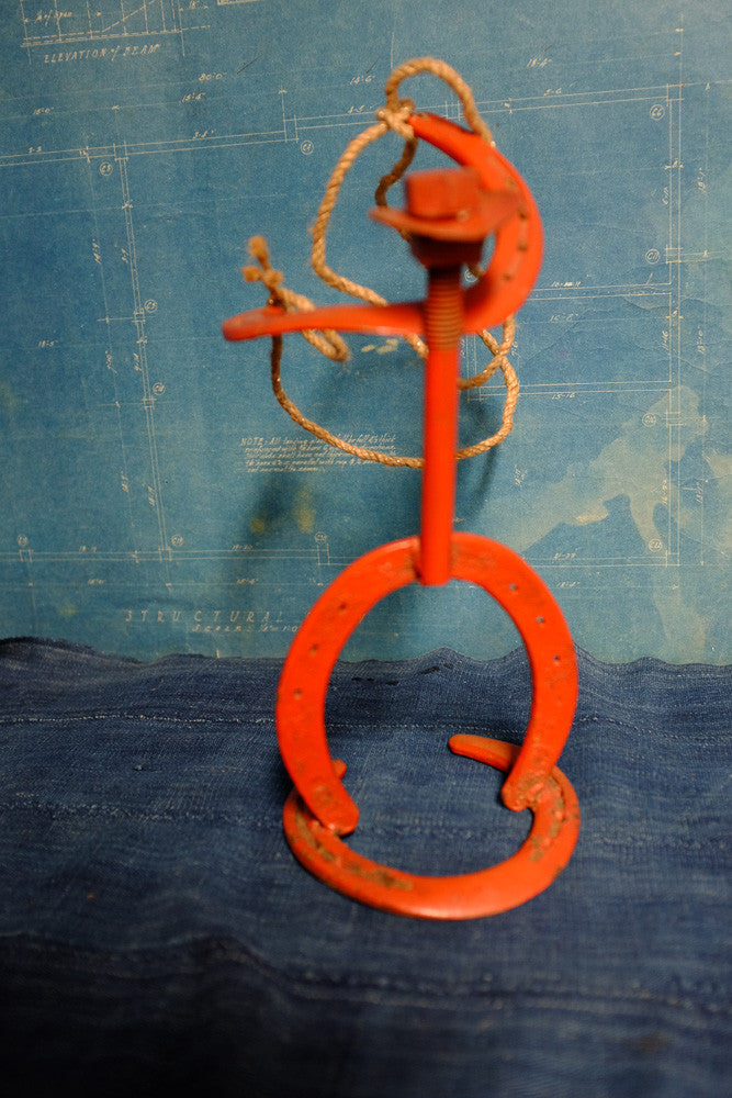 Vintage horseshoe cowboy folk art sculpture.