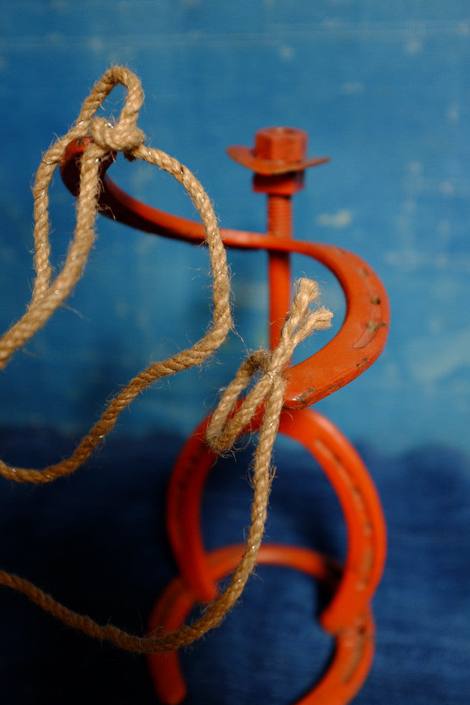 Vintage horseshoe cowboy folk art sculpture.