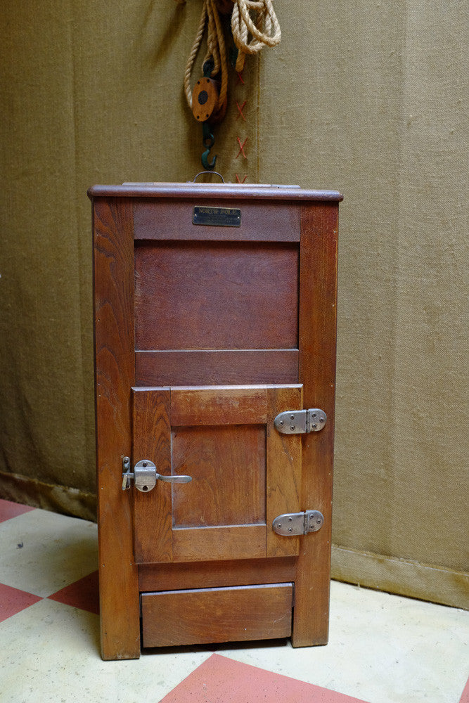 Vintage icebox cooler with antique oak wood design.