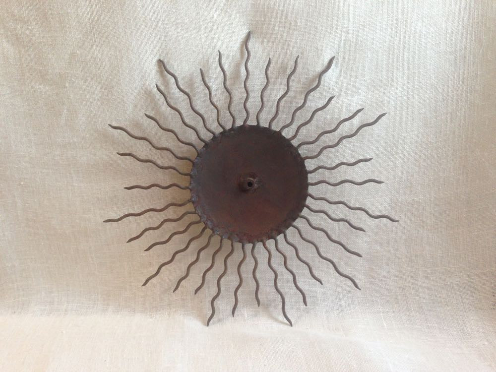 Indoor/Outdoor Sun Plaque.
Rusty iron sun plaque with intricate details