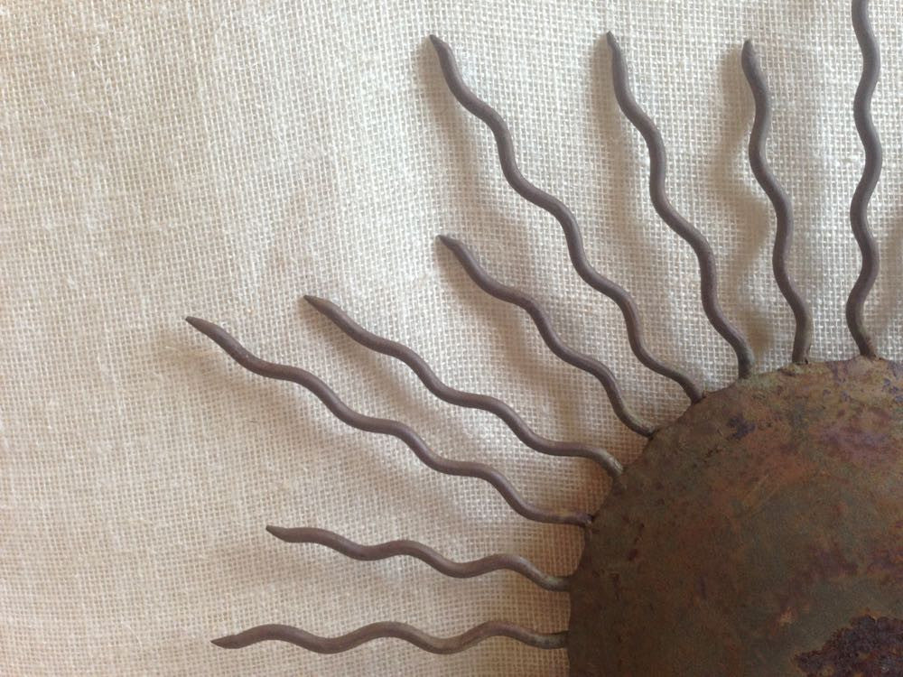 Indoor/Outdoor Sun Plaque.
Rusty iron sun plaque with intricate details