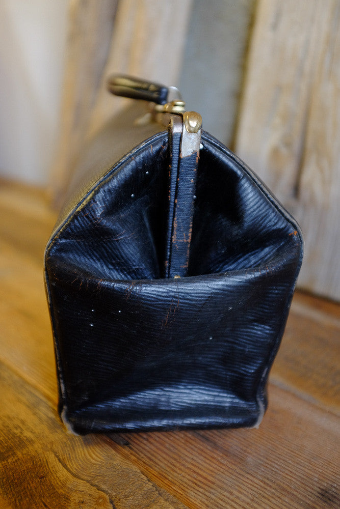 Vintage black leather medical bag with original blue silk interior.