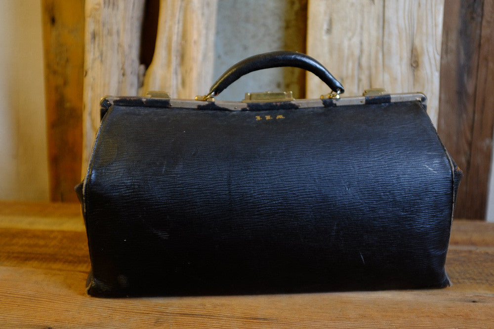 Vintage black leather medical bag with original blue silk interior.