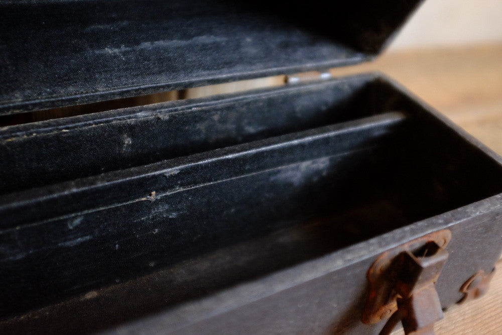 Vintage black suitcase with rusty hardware