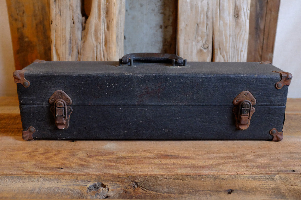 Vintage black suitcase with rusty hardware