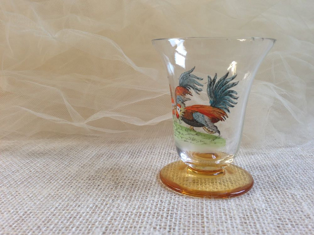 Vintage French rooster crystal glassware on a lace tablecloth