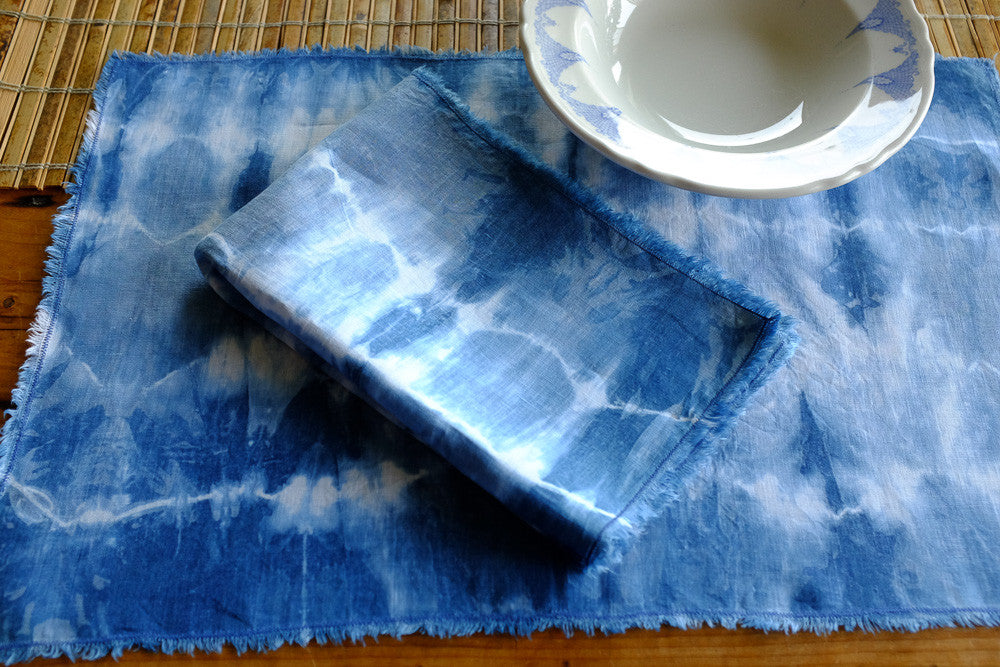Handmade indigo tie-dyed linen placemats.