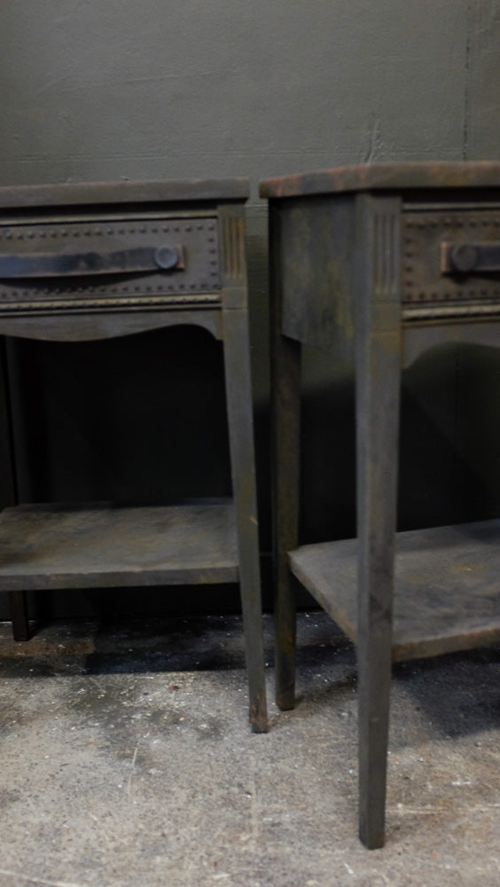 Charcoal side tables with provincial style and distressed leather handles.