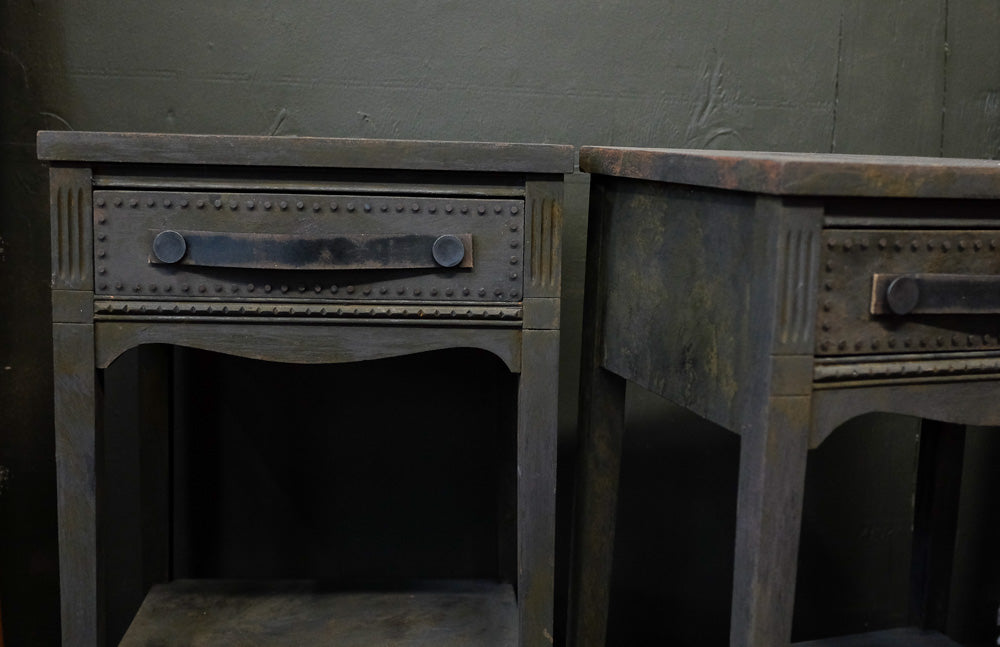 Charcoal side tables with provincial style and distressed leather handles.