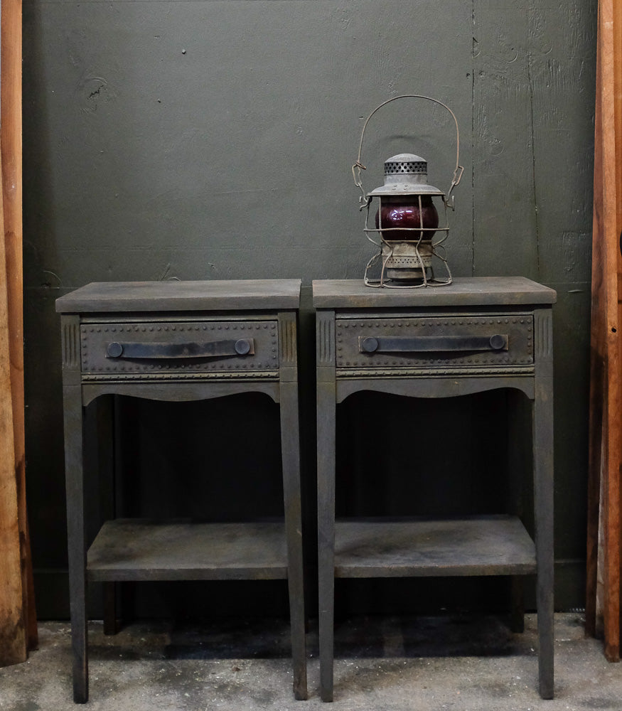 Charcoal side tables with provincial style and distressed leather handles.