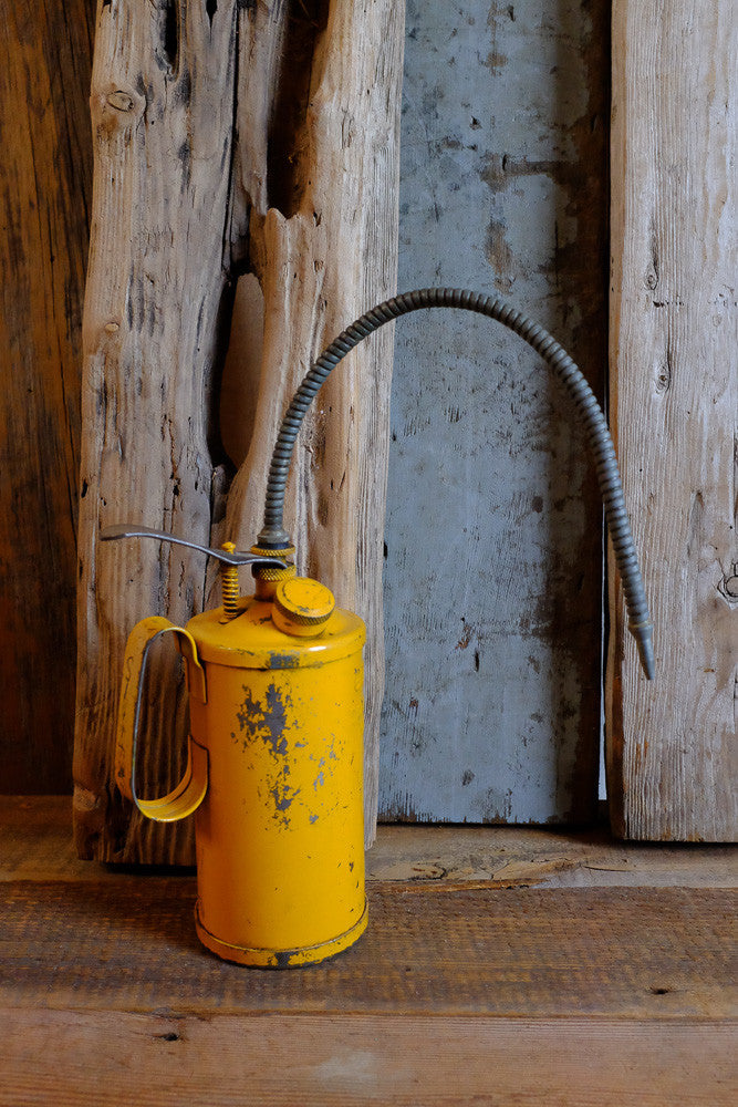Vintage oil can with embossed letters 